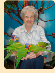 Photo: A Phoenix Society member with macaws